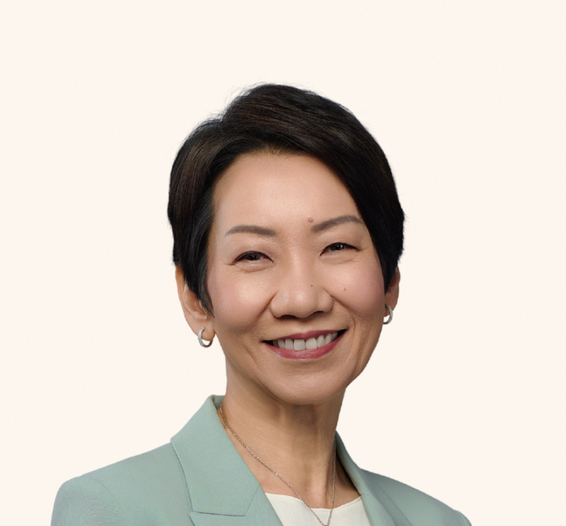 Minister Grace Fu in green blazer, smiling warmly against a light background.